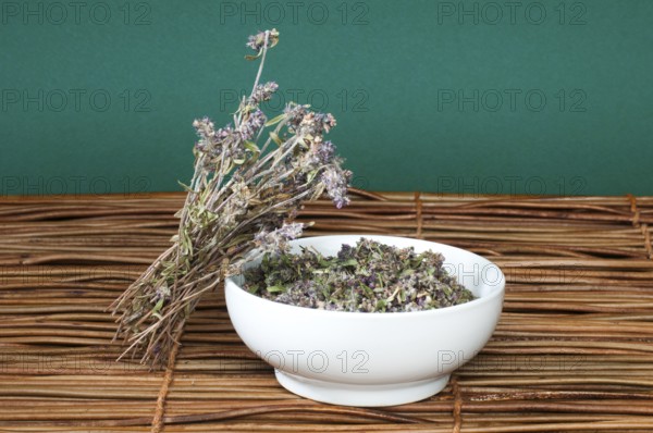 Dried thyme in a bowl on a wooden base