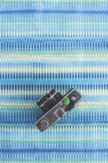 Vintage photocamera on blue paper background