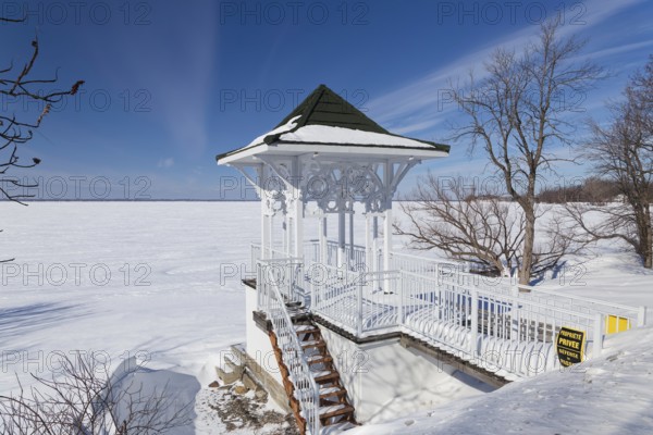 Winter, small private pavilion next to the snow and ice covered Saint Lawrence River, Lery, Province of Quebec, Canada, North America