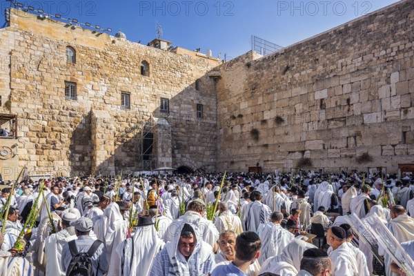 JERUSALEM, ISRAEL - SEPTEMBER 26, 2018: Touching ceremony at the Western Wall. Jews praying at the Western Wall wrapped in festive white Talit. The blessing of the Cohanim. The concept of pilgrimage