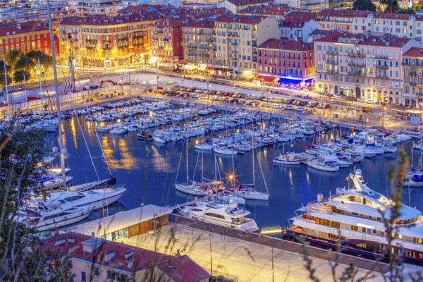 Idyllic view of the harbor, boats and promenade with several cafes, Rade de Villefranche in Nice, illuminated night scene