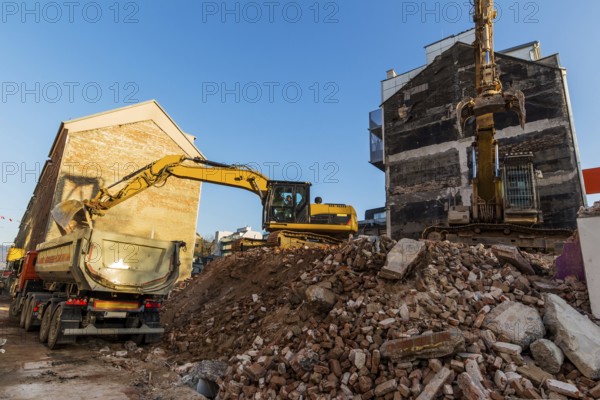 Excavators on a building site demolishing a house, creating space for new flats and living space Austria