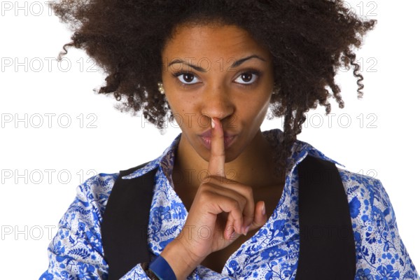Young African American woman holding index finger in front of mouth - cropped on white background