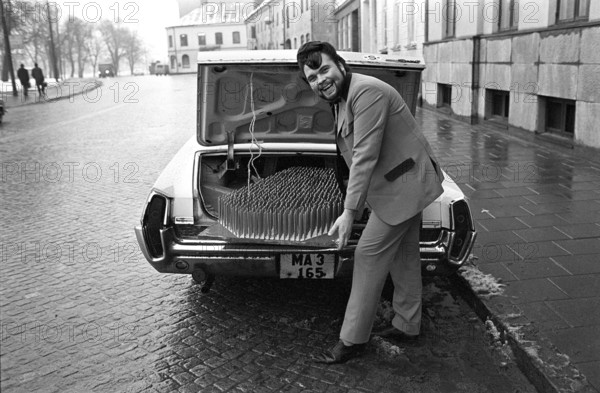 A fakir with his mat of nails. The Swedish fakir Mr. Swing, whose real name was Kjell Swing (1942-1988). Pictured in Malmö Sweden transporting his bed of spikes in the trunk of his car, a Pontiac grand prix 1964. 1969
