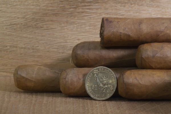 Luxury Cuban cigars with US dollar on the wooden table