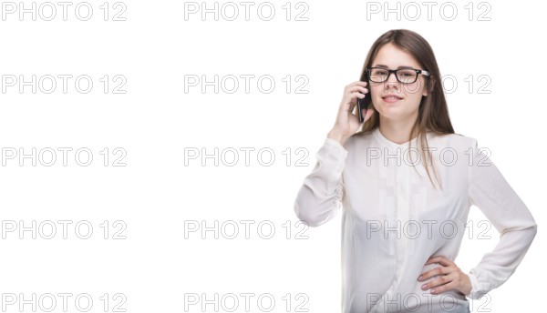 Smiling businesswoman in glasses talking on mobile phone. Beautiful young girl in white shirt on white isolated background talking on mobile phone. Woman in shirt with cellphone. Copy space. Blank