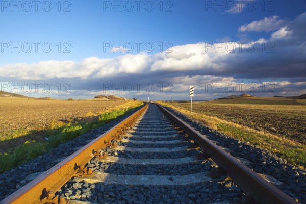 Single railway track at sunset, Central Bohemian Uplands, Czech Republic. Railway track in nature park Central Bohemian Highlands, Czech Republic, Europe