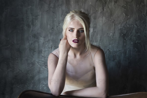 Portrait of beautiful young woman on dark background