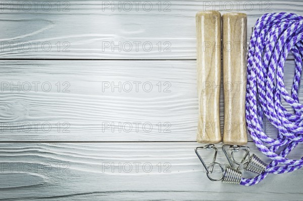 Jump rope on wooden board copy space sports training concept