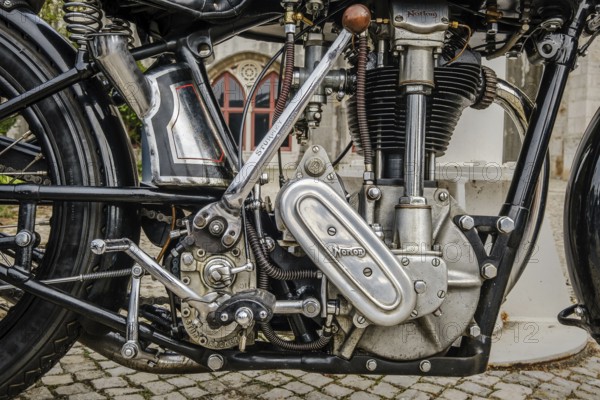 Lisbon, Portugal - Oct 15, 2023: Close-up of engine area of iconic Norton ES2 motorcycle by Norton Motors Ltd, Aston, Birmingham, parked on cobblestone road. Reliable and very popular long stroke single of traditional design