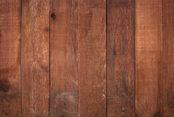 Red weathered barn wood background with knots and nail holes