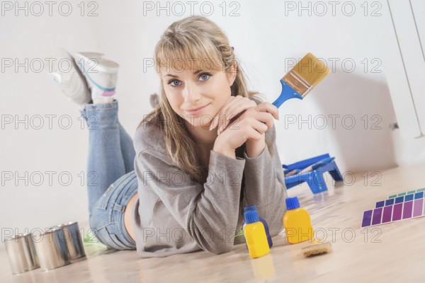 Beautiful housewife painting at home