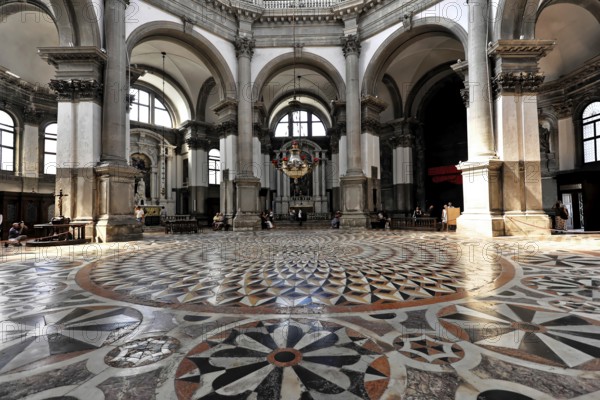 Interior view of the church of Santa Maria della Salute, Venice, Wide-angle view of a church interior with arcades and marble floor, Venice, Veneto, Italy, Large interior of a church with impressive portico and geometric floor pattern, Venice, Veneto, Italy, Europe