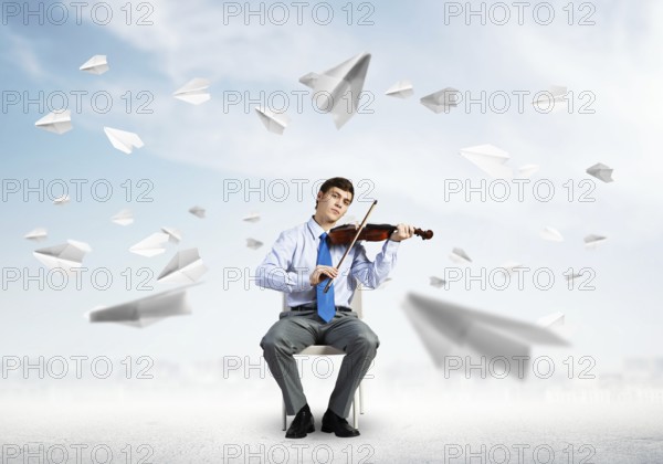 Young businessman is engaged in music, concept of creative chaos in business