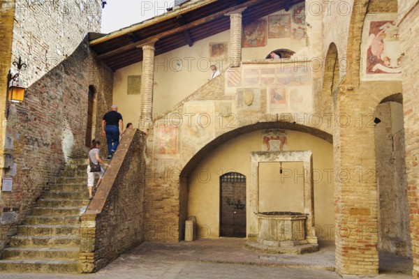 Tourists visit the Museo Civico, San Gimignano, Tuscany, Italy, Europe