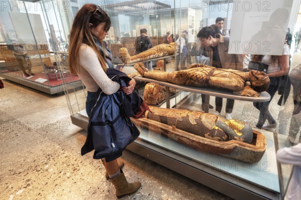 London, United Kingdom, May 13, 2019: The British Museum, London. Hall of Ancient Egypt, tourist admiring ancient mummies exhibition, Europe