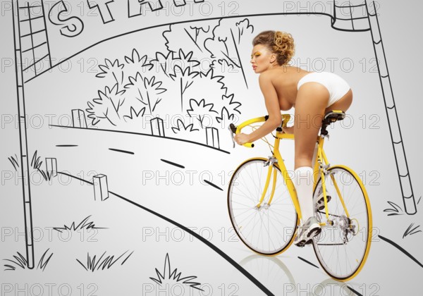 Back view of a sexy pin up cyclist in white erotic panties on a yellow racing bike on a sketchy background of a race starting area