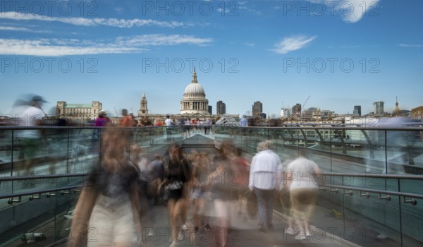London, UK, July 5, 2019: People walking on the millennium bridge and Saint Paul Cathedral in London UK