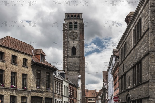 Tournai Doornik, Walloon Region Belgium, 08 14 2019: Facades of residential and commercial buildings in old town with the tower of the Saint Brice church