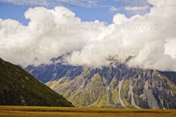 Mount Cook Range under blue sky and thick clouds on the South Island of New Zealand
