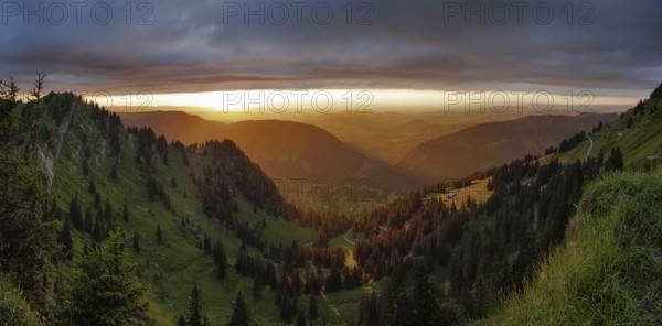 Panoramic view of a light and weather scene over the foothills of the Alps, taken from the Nagelfluhkette, Allgäu. In the centre in the background Oberstaufen and on the left the Seelekopf