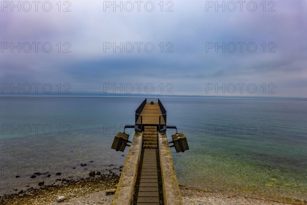 Waterfront and a Pier on Lake Neuchatel in Old Town in a Foggy Winter day in City of Neuchatel, Canton Neuchatel, Switzerland, Europe