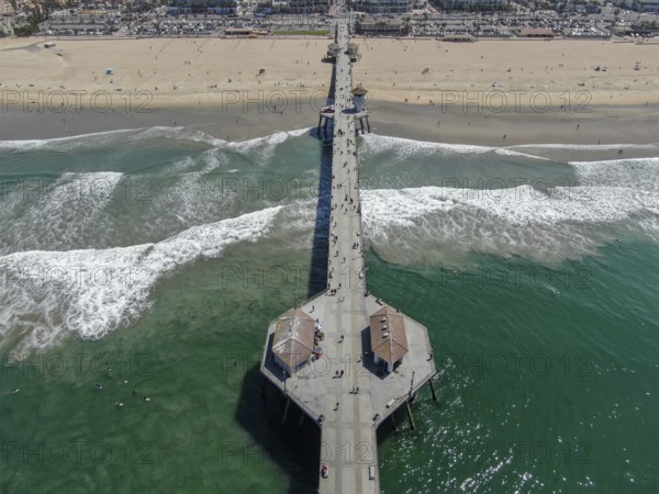 Aerial view of Huntington Pier, beach and coastline during sunny summer day, Southeast of Los Angeles. California. destination for surfer and tourist