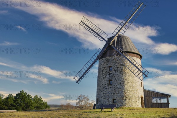 A windmill in the field in the daytime