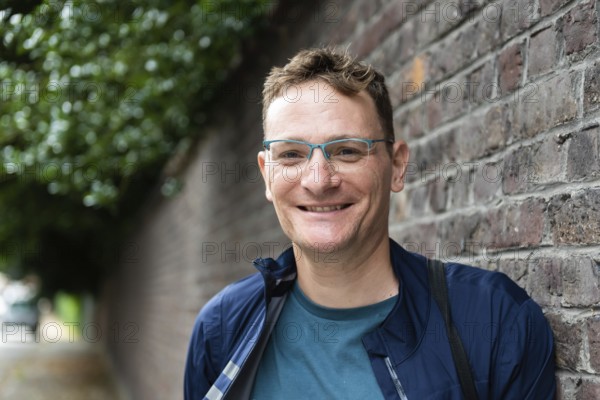 Portrait of an attractive forty year old man standing against a wall, Kortrijk