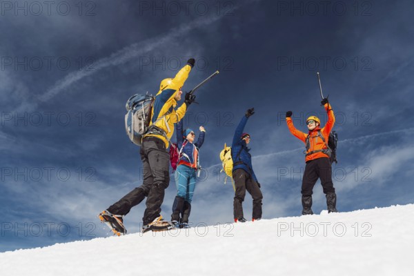 Mountaineer backcountry ski touring in the mountains. Ski touring in high alpine landscape with snowy trees. Adventure winter extreme sport.