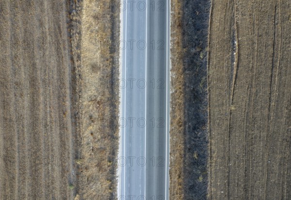 Drone aerial of countryside rural empty road. Dry land