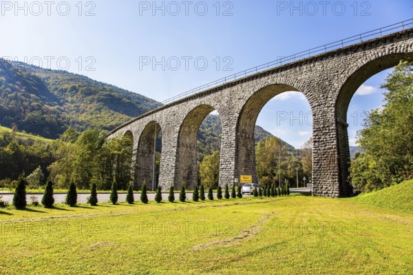 Picturesque Julian Alps. Beautiful sunny autumn day. Majestic powerful bridge over the river Idrija. The beauty of the Julian Alps. Travel to Slovenia