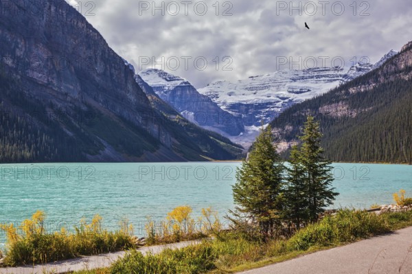 A great sunny day. Rocky Mountains, Canada, Banff National Park. Magnificent Lake Louise with emerald water surrounded by glaciers, North America