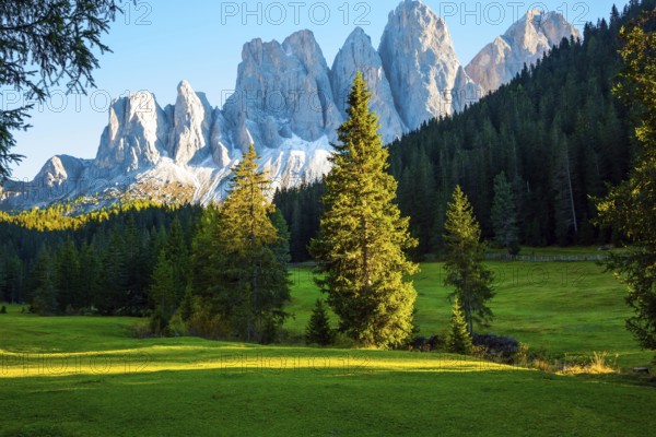Italy. Majestic Dolomites. Powerful mountain peaks surround the piicturesque green valley Val di Funes. The concept of active, ecological and photo tourism