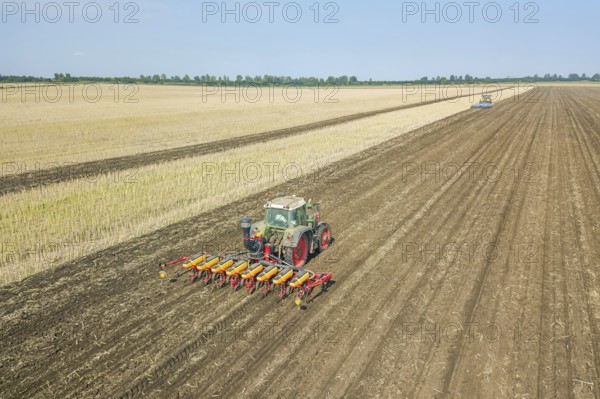 Farmer seeding crops at field. Seeding Aerial View