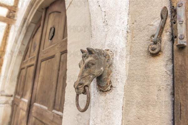 Old rusty horse's head with a ring for tying horses in a backyard. Colmar, Haut-Rhin, Collectivite europeenne d'Alsace, Grand Est, France, Europe