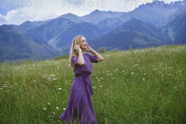 Serene blond woman walking in mounain meadow, USA, North America