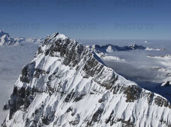 Harsh mountain peak next to the Titlis, sea of fog