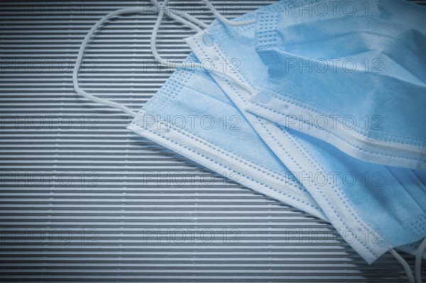 Medical disposable face masks on striped background
