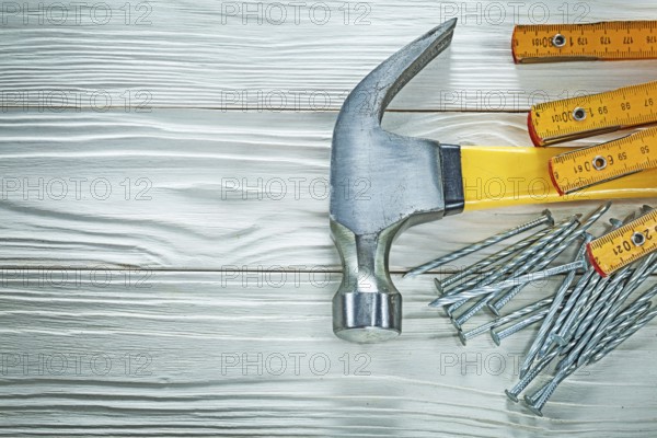 Wooden meter claw hammer stainless nails on wood board