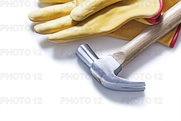 Claw hammer and yellow leather gloves isolated