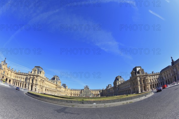 Paris, September 8: The world-famous Louvre - September 8, 2012 in Paris. Tourists take pictures of the glass pyramid entrance. Traces in the sky jet. Picture taken Fisheye lens