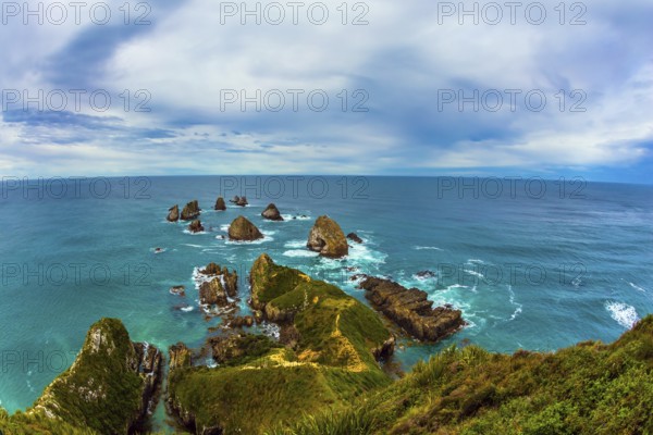 Nuggets Point is a landmark relief on the Otago coast, surrounded by rocky islets. Travel to New Zealand. The concept of active, eco and photo tourism