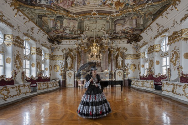 A woman in a black dress stands in a magnificent room with frescoed ceilings, staged photo shoot, Donau-Ries district, Bavaria, Germany, Europe