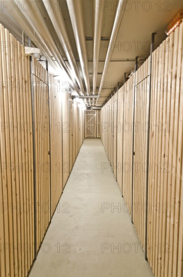 Aisle in a cellar with wooden storage units