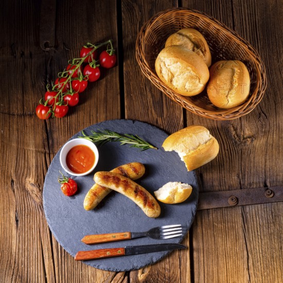 Rustic bratwurst with ketchup and fresh rolls