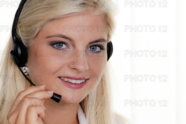 Young woman with headset on the phone at Call Centre Austria