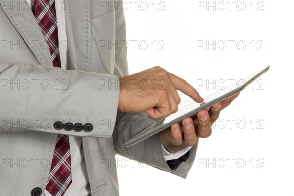 A manager or entrepreneur holds a tablet computer in his hand Austria
