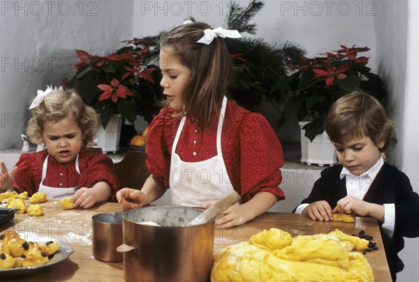Crown princess Victoria of Sweden. Pictured with her sister princess Madeleine and brother prince Carl Philip when baking tradtional lucia buns 1984