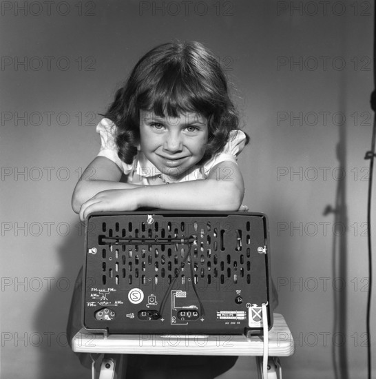 In the 1950s. A girl with a Philips radio set with the backside of the radio visible where the sockets for external antennas are placed. Sweden 1959. Kristoffersson ref CG70-12